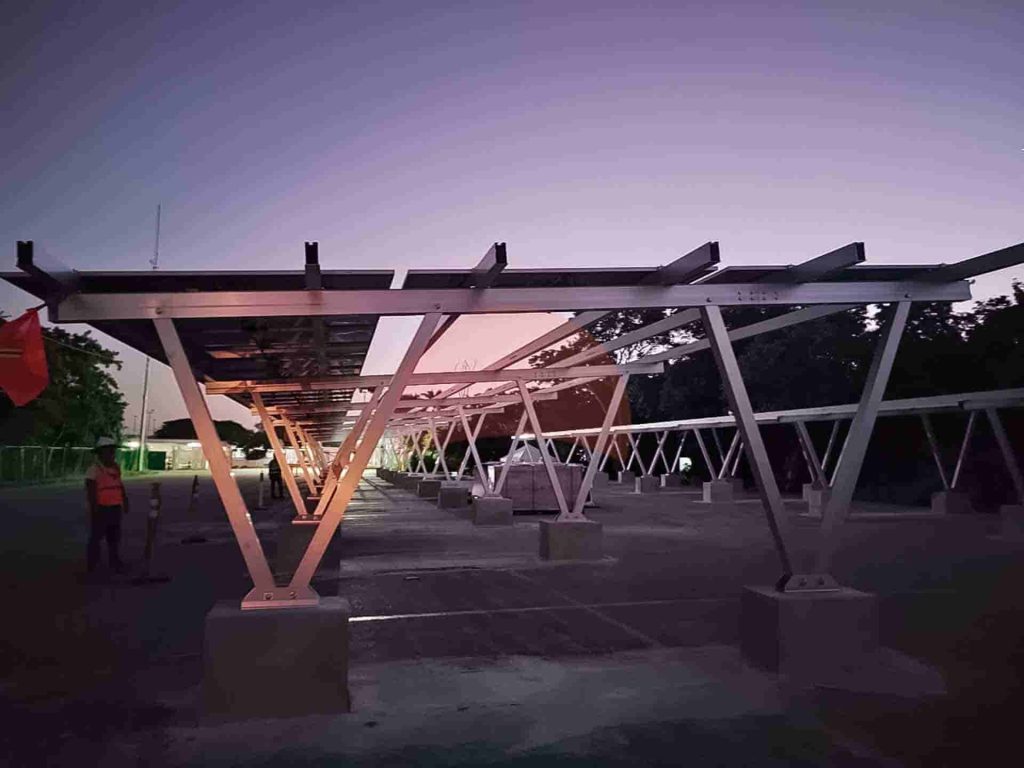 carport during installation with sunset on the back