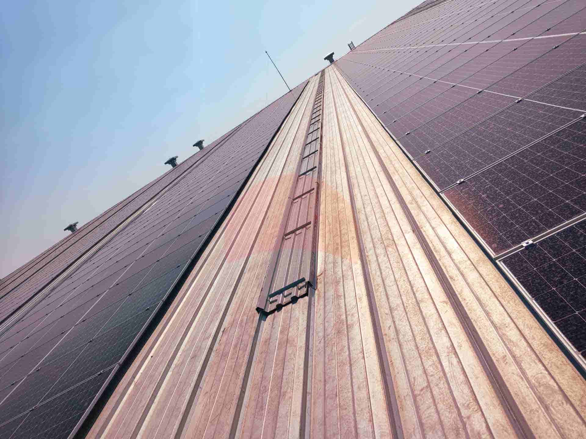 steel roof with solar panels blue sky on the horizon